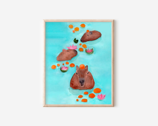 An art print featuring three capybaras, swimming in light blue water among oranges and lotuses.