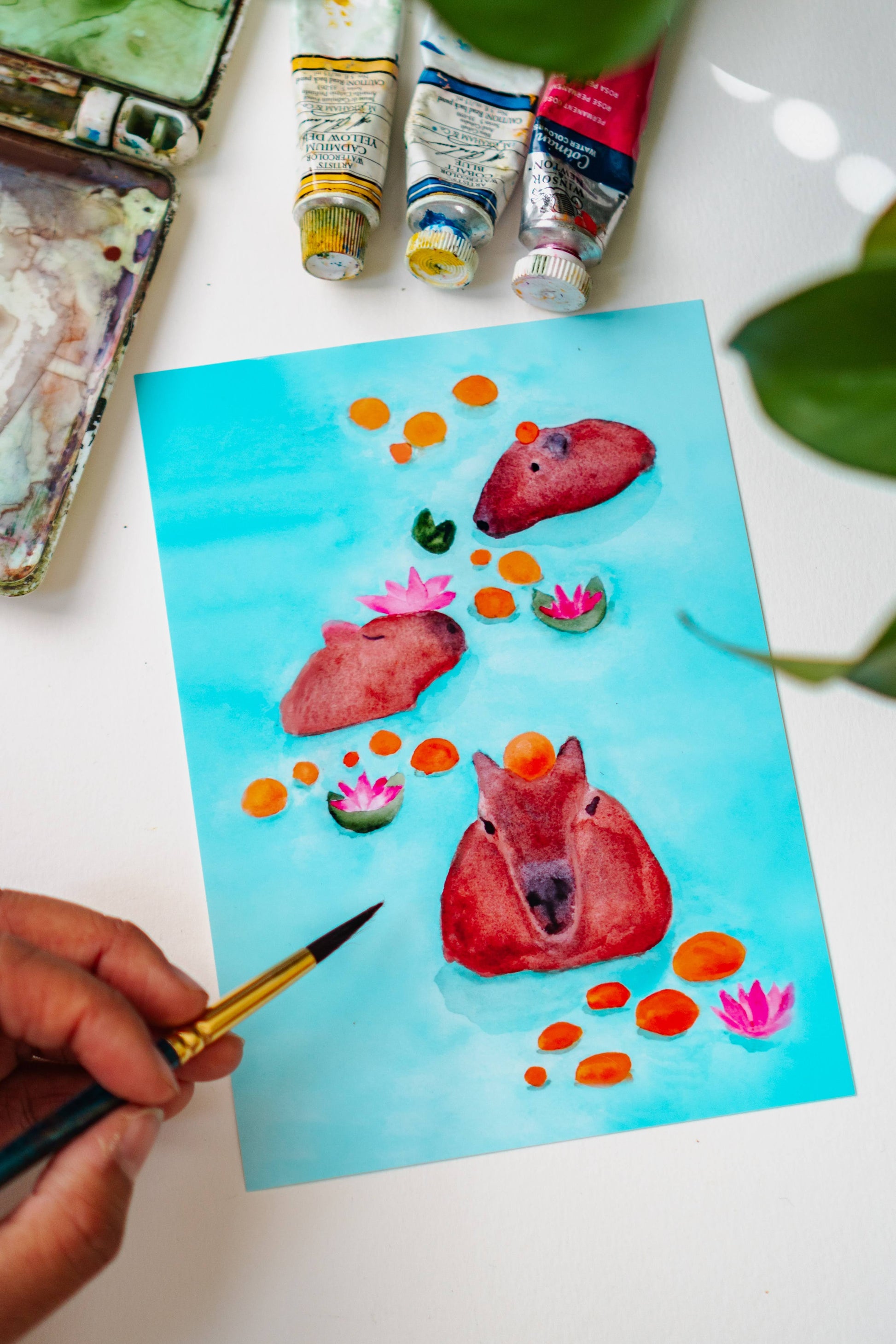 A photo of Menmin Made painting the Capybaras Swimming in Oranges Art Print.