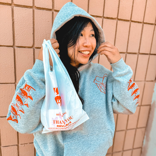 Woman smiling wearing grey hoodie