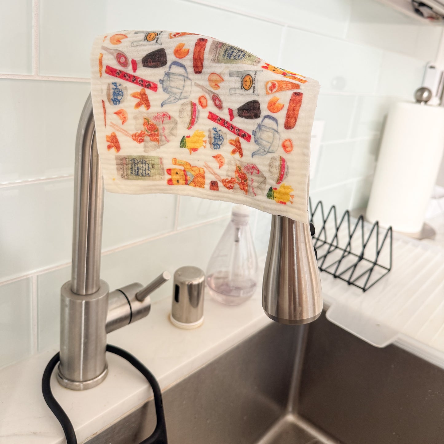 Swedish dishcloth with classic Chinese takeout items on the water tap