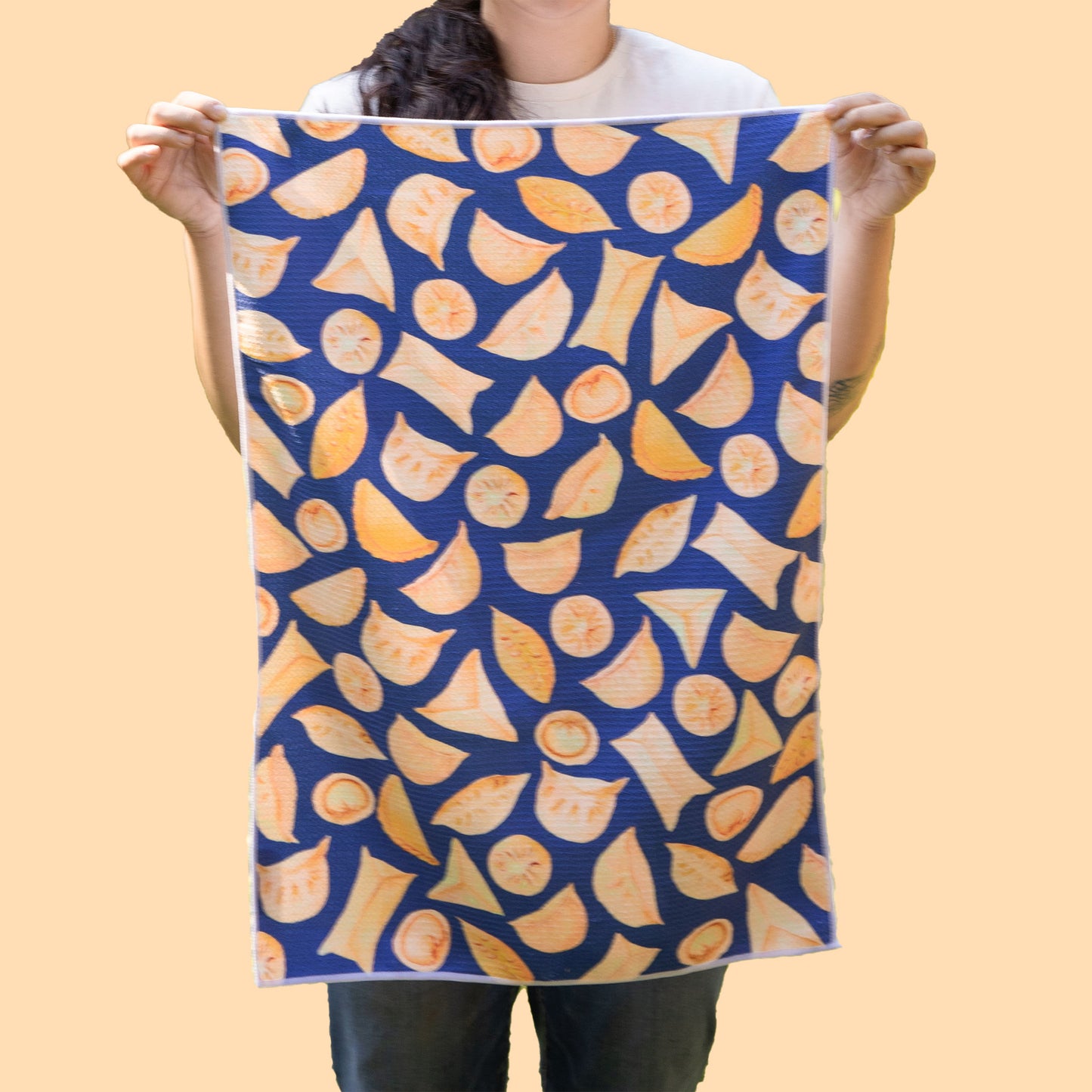 Unfolded potsticker tea towel held up by the corners