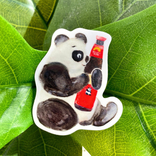 A watercolor sticker of a panda smiling and holding a red bottle of Panda brand oyster sauce.