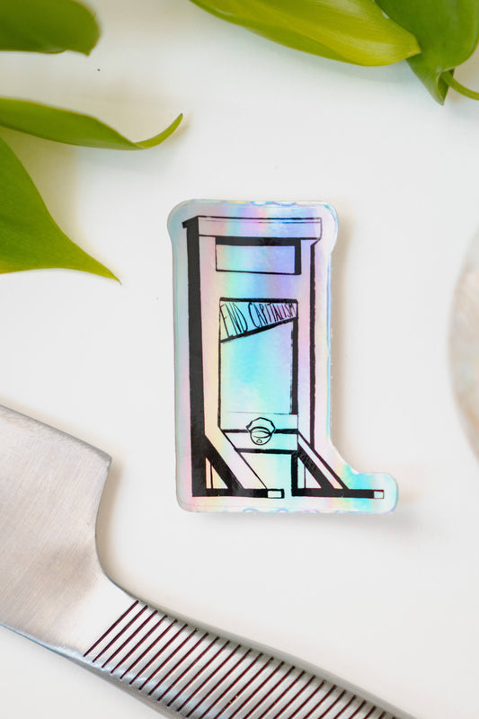 A holographic sticker of a guillotine, with the words "End Capitalism" written on the blade.