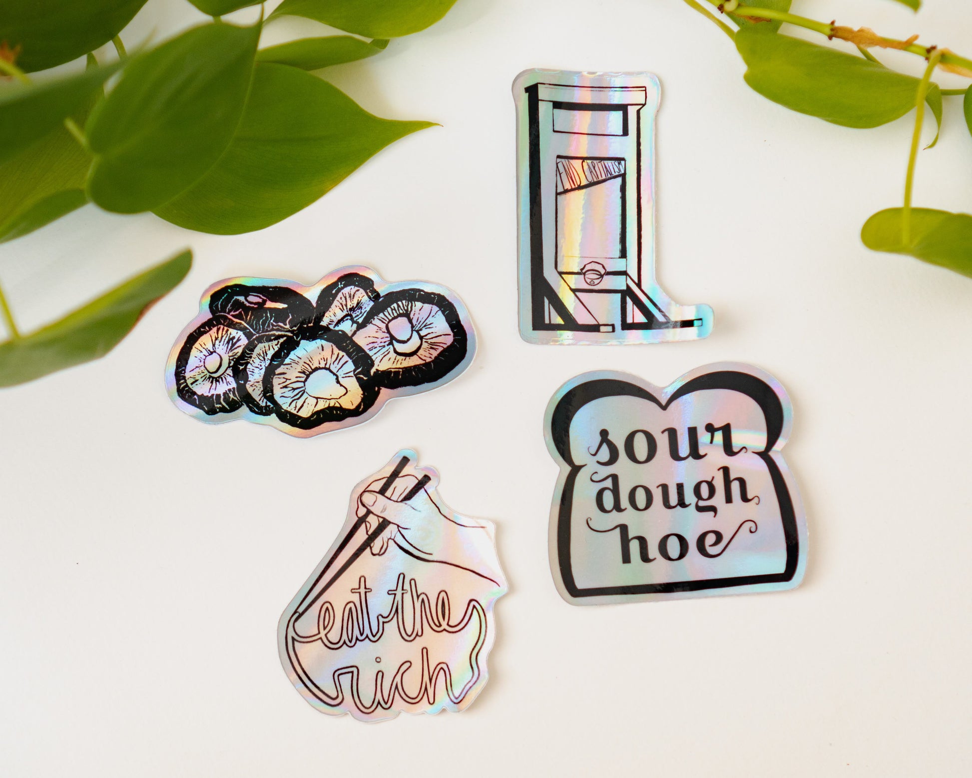 Menmin Made's collection of holographic stickers, including the Sourdough Hoe Sticker.