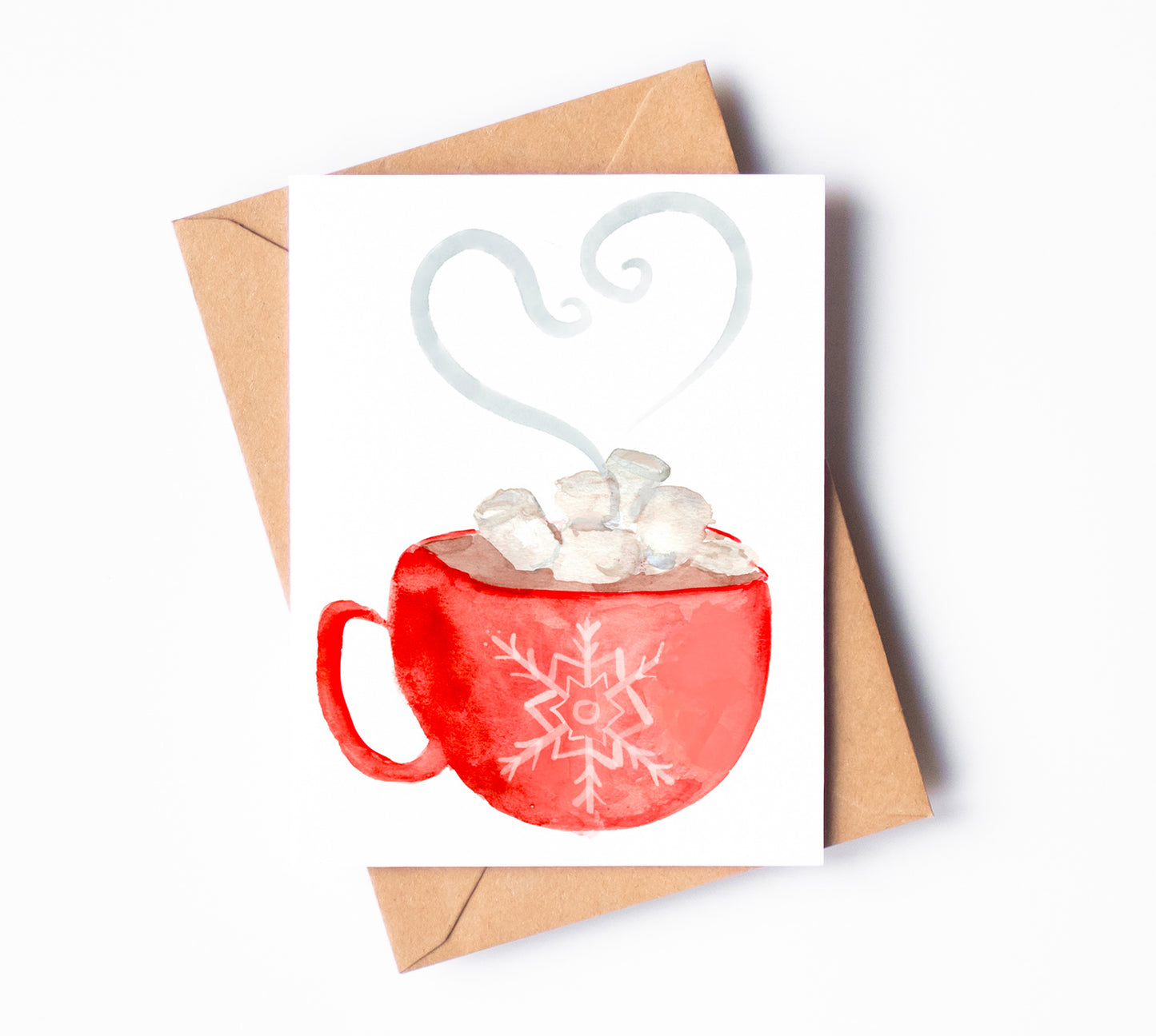 A greeting card with a steaming mug of hot chocolate. A red mug embellished with a snowflake holds hot cocoa and marshmallows.