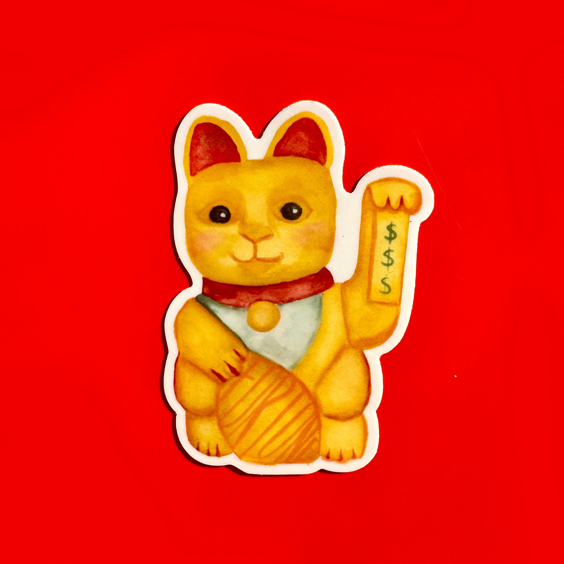 sticker of a yellow lucky cat and dollar signs