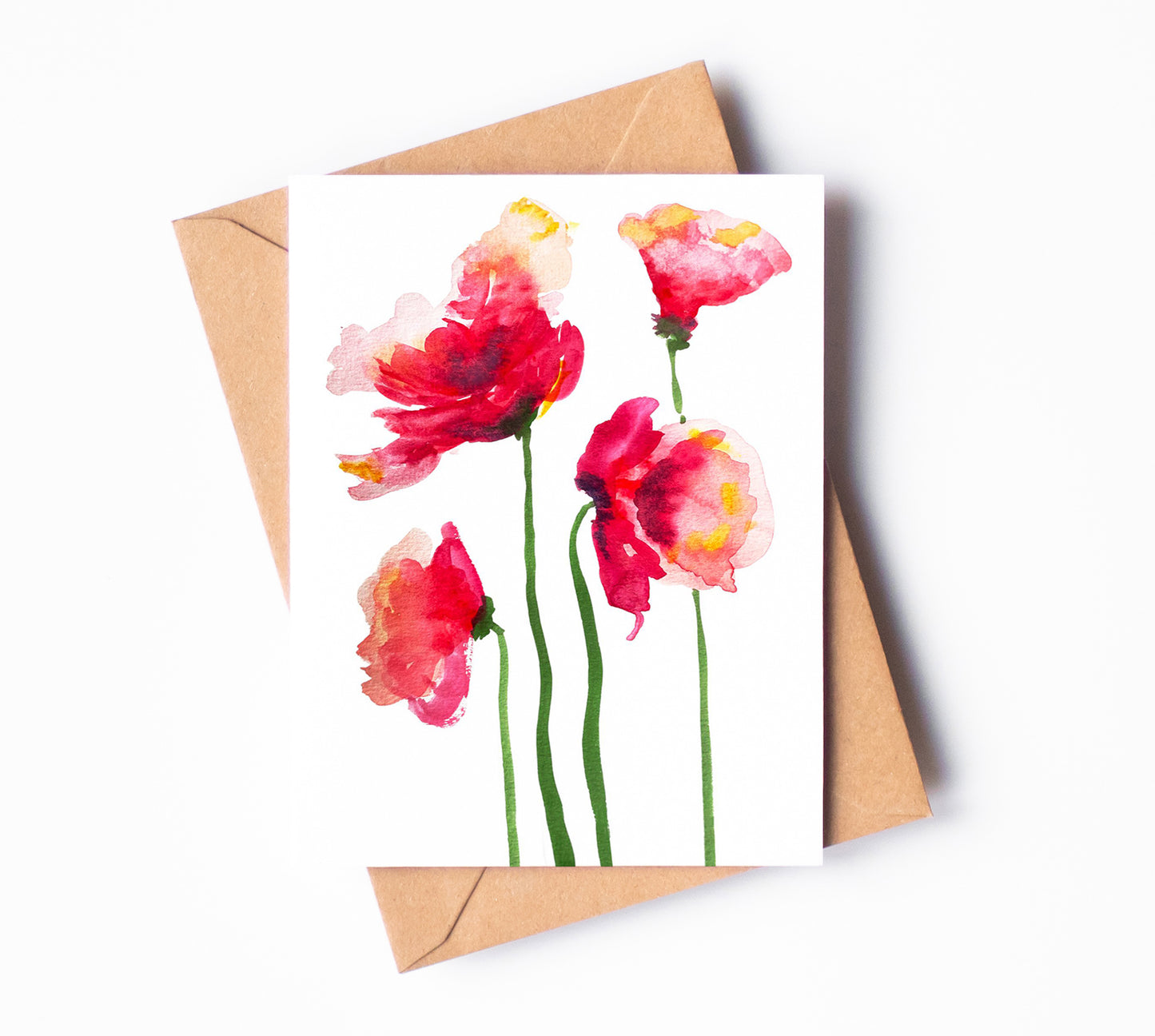 A soft, red and pink watercolor greeting cardof four California poppies. The petals are lit with soft, yellow accents.