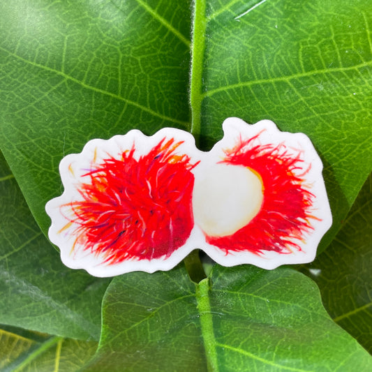 A sticker of two spiky, bright red rambutan fruits. One fruit is half peeled, revealing the soft and sweet inside of the fruit.