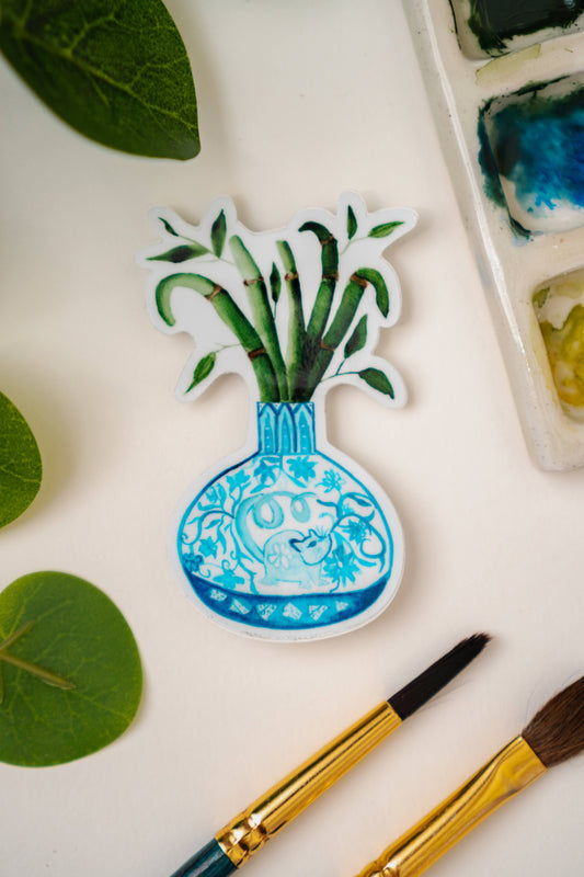 A sticker of a bamboo plant in a blue and white porcelain vase, decorated with a rat.