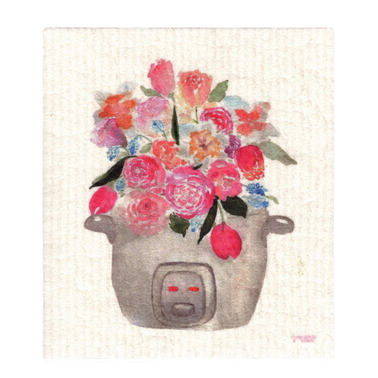 A textured Swedish dishcloth depicting a pink, blue, and white bouquet of tulips, roses, and other flowers sprouting out of a rice cooker.