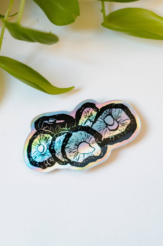 A holographic sticker featuring six shiitake mushrooms rendered in ink.