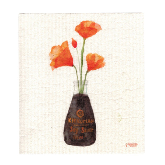 A white, textured Swedish dish cloth depicting four orange California poppies in a Kikkoman soy sauce bottle.