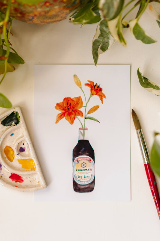 A watercolor art print of two orange tiger lilies in a Kikkoman soy sauce bottle.