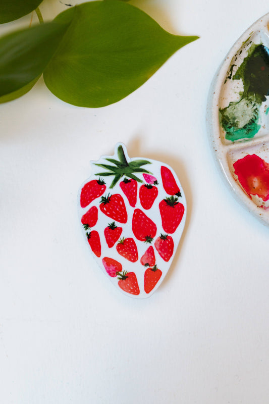 A watercolor sticker of several smaller, red strawberries making up one large strawberry.