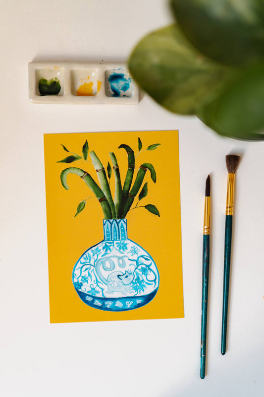A print of a bamboo plant in a blue and white porcelain vase, decorated with a rat.