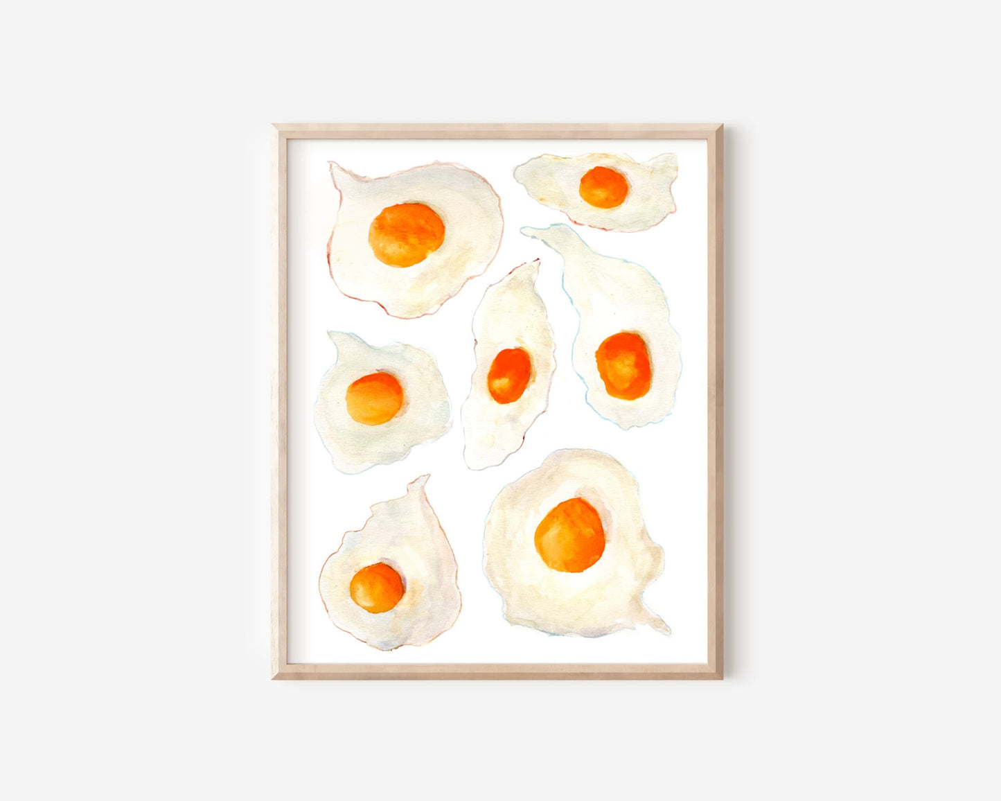A watercolor print of seven sunny side up eggs with bright orange yorks and crispy colorful edges.