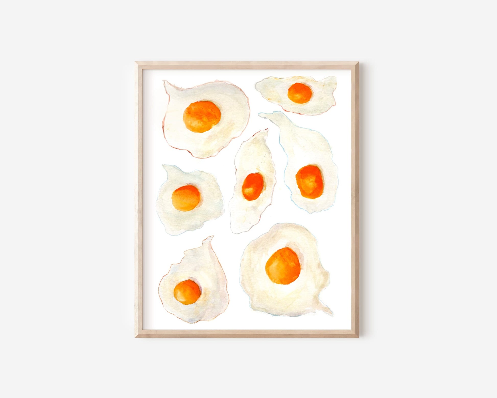 A watercolor print of seven sunny side up eggs with bright orange yorks and crispy colorful edges.