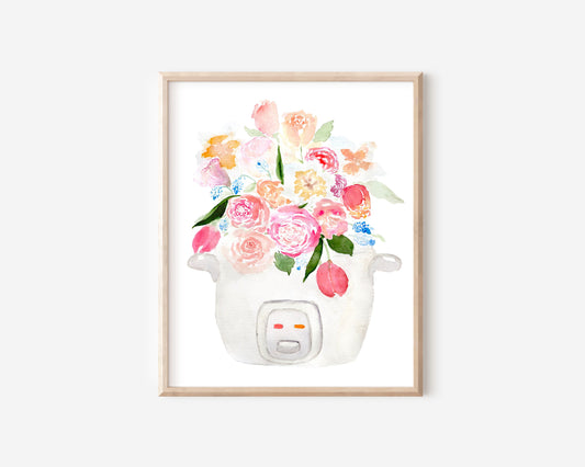 A pink, blue, and white print of a bouquet of tulips, roses, and other flowers sprouting out of a rice cooker.