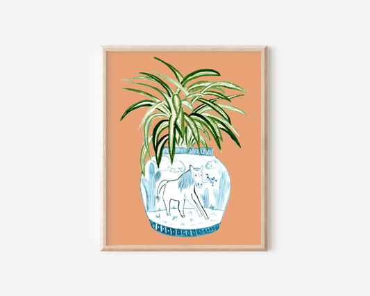 A print of a spider plant in a blue and white porcelain vase, decorated with a horse.