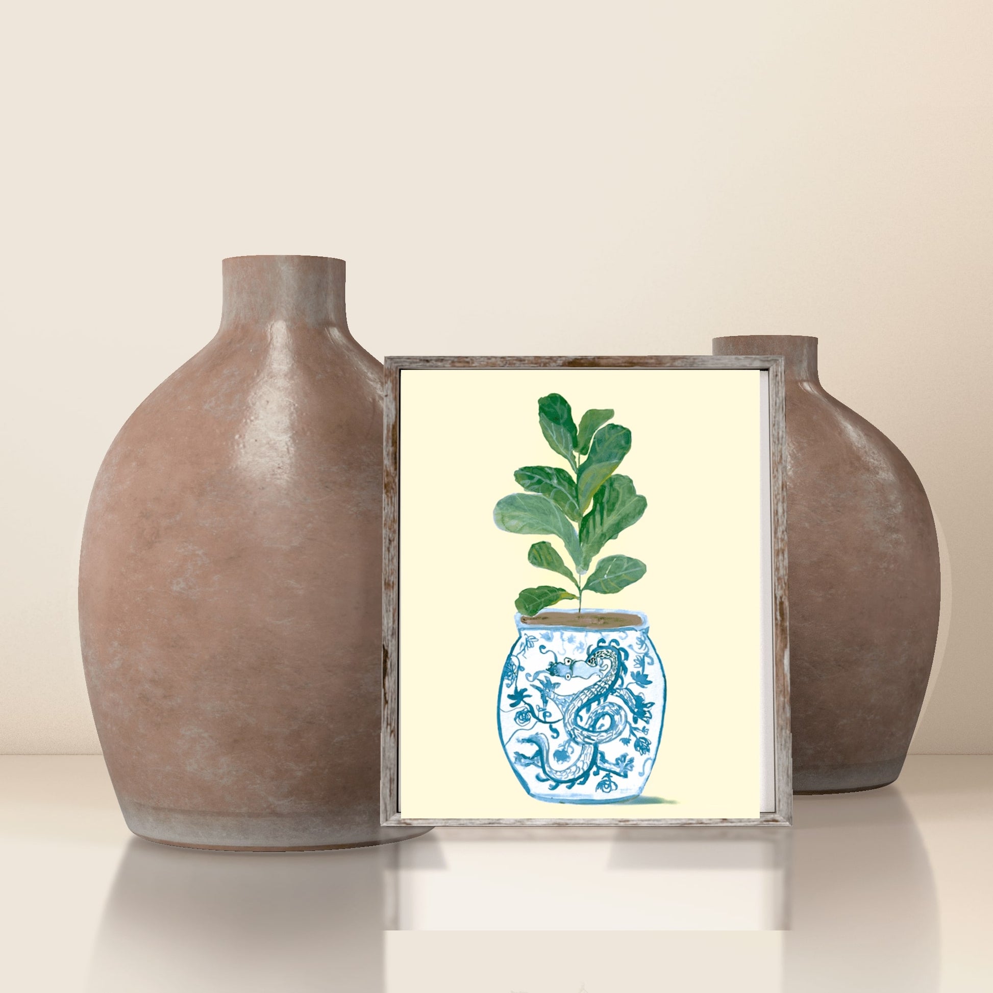 A print of a fiddle-leaf fig plant in a blue and white porcelain vase, decorated with a dragon.