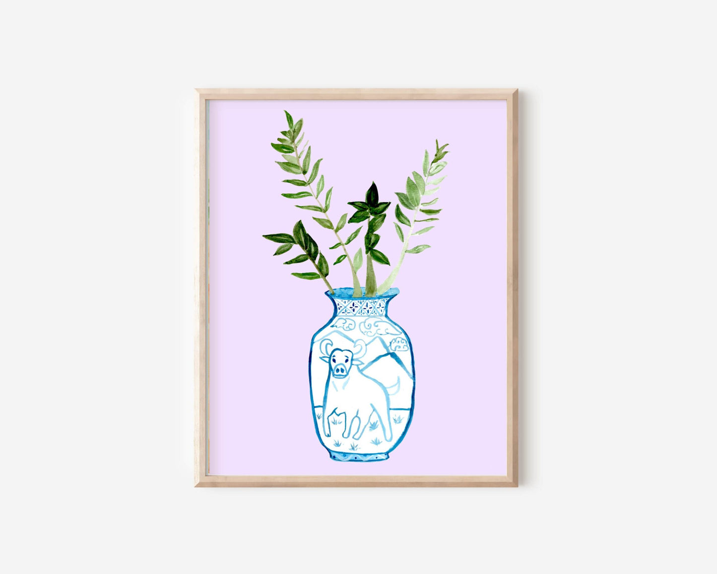 A print of a ZZ plant in a blue and white porcelain vase, decorated with an ox.