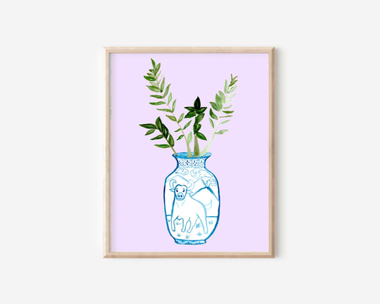 A print of a ZZ plant in a blue and white porcelain vase, decorated with an ox.