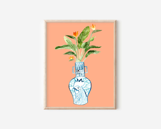 A print of a bird of paradise plant in a blue and white porcelain vase, decorated with a rooster.