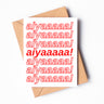 A white greeting card with "aiyaaaaa!" written seven times on it.