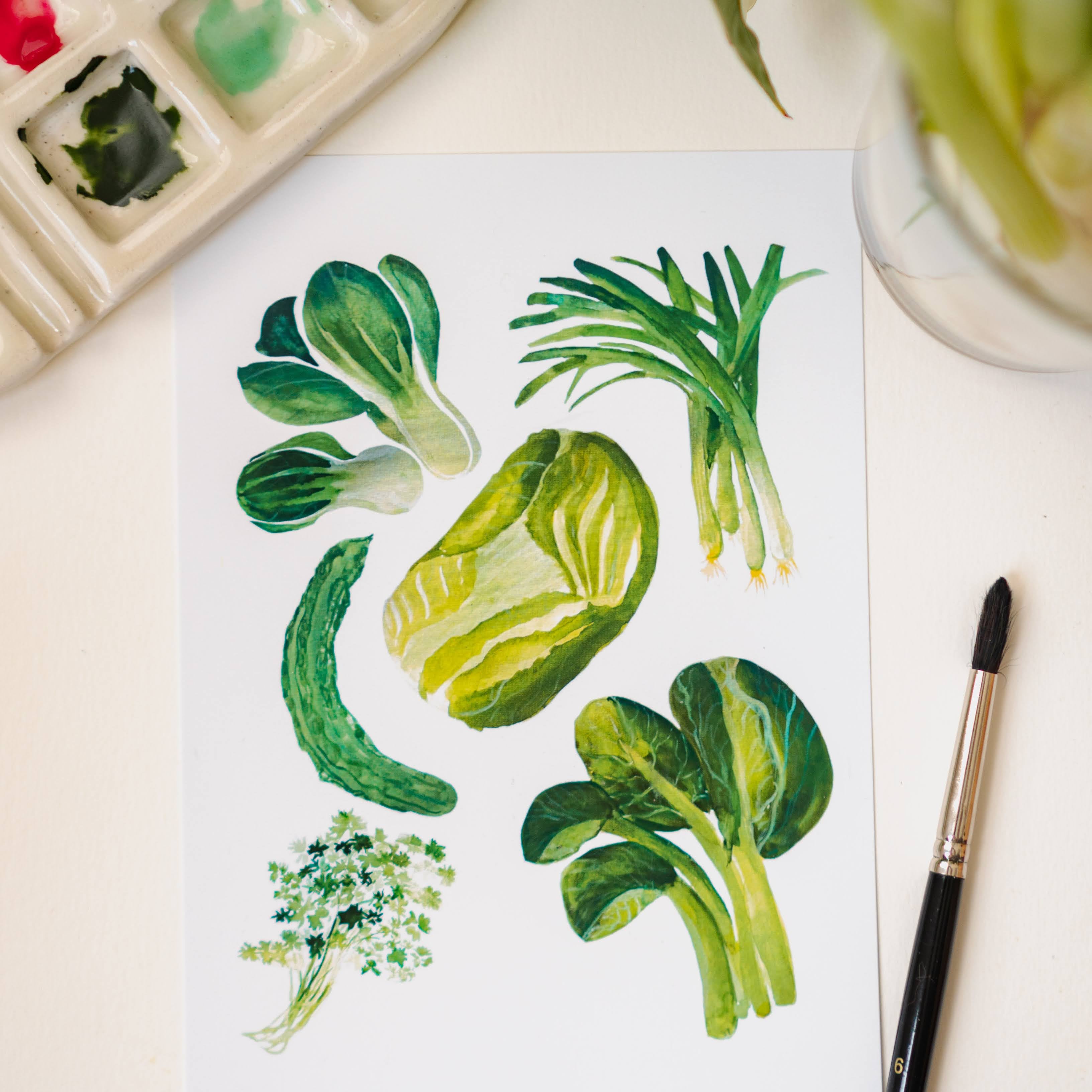 A white art print depicting green Chinese vegetables: cilantro, green onion, bok choy, and napa cabbage.