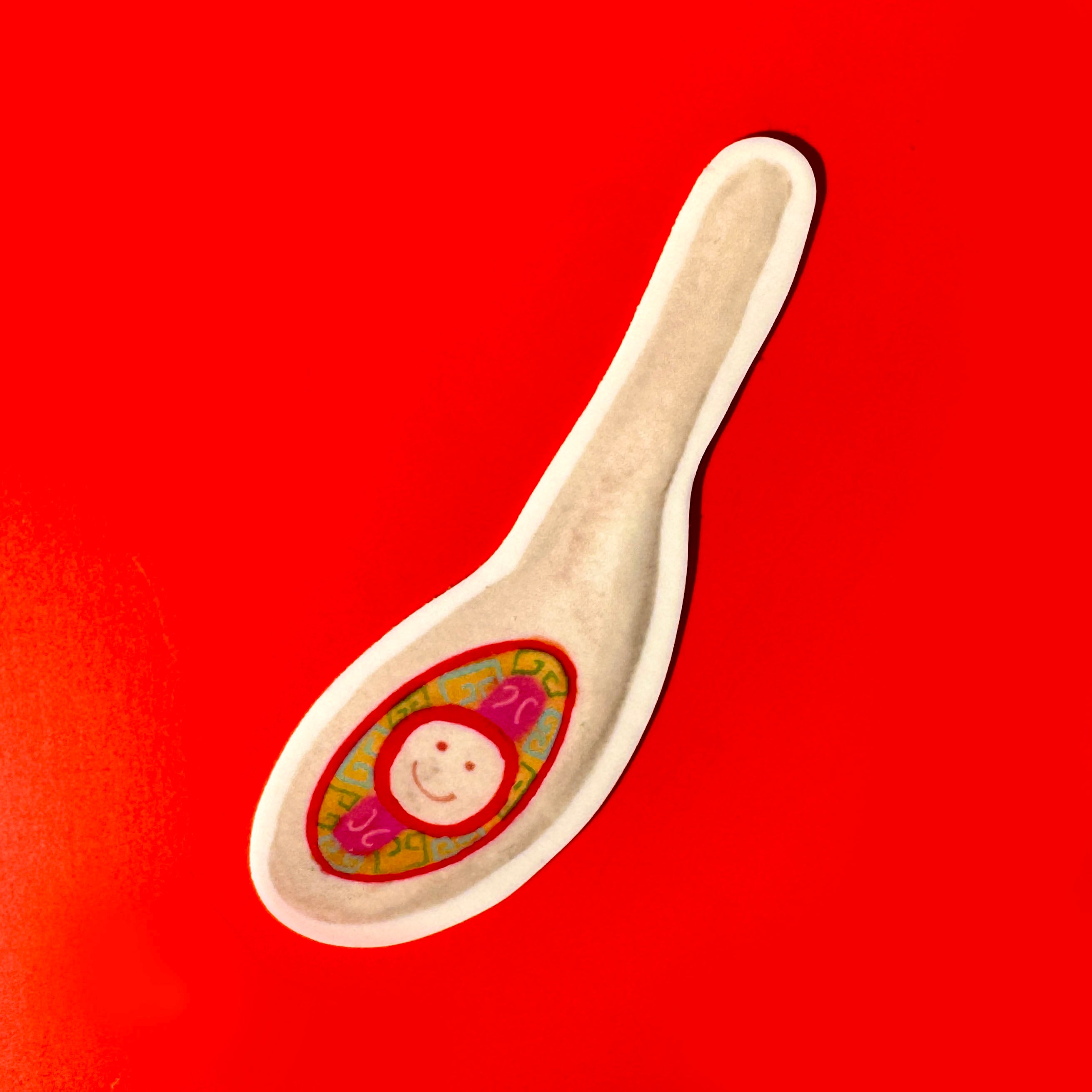 sticker of Asian soup spoons with a smiley face inside