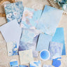 Assorted blue vintage decorative papers with florals, watercolor, and marble prints, plus die-cut tag and butterfly shapes"