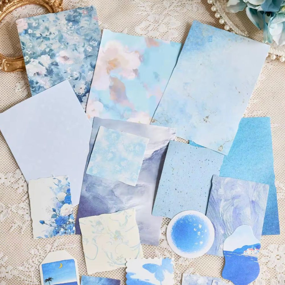 Assorted blue vintage decorative papers with florals, watercolor, and marble prints, plus die-cut tag and butterfly shapes"