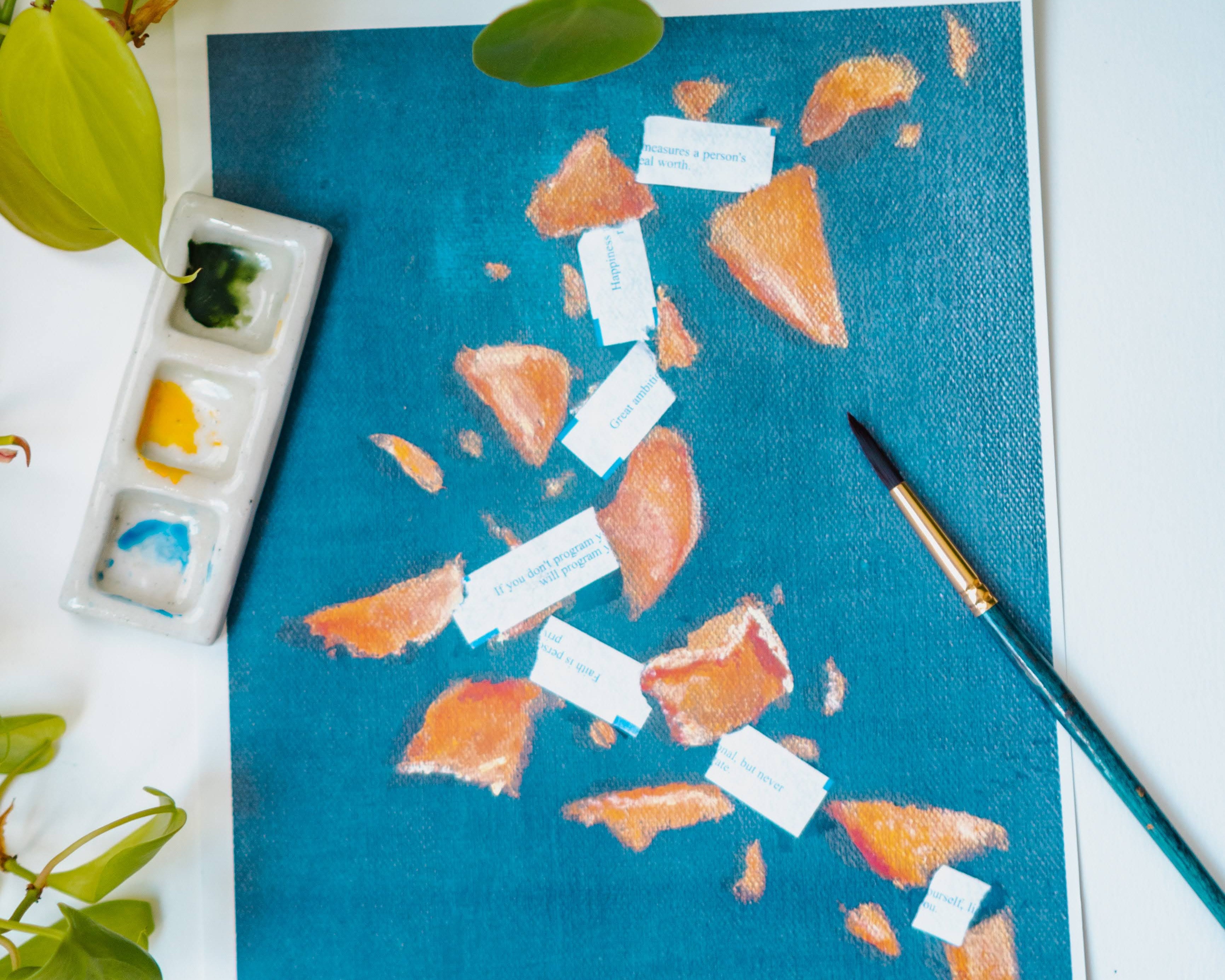 A watercolor print of broken fortune cookies and scattered fortunes on a blue background.