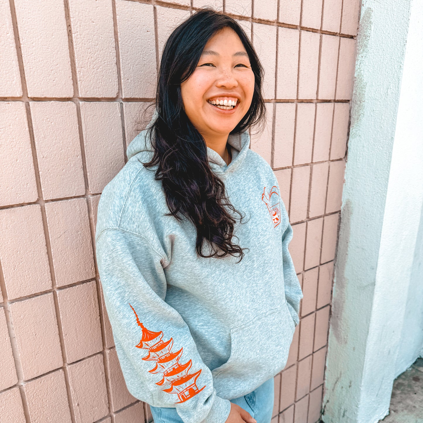 Woman smiling wearing grey hoodie