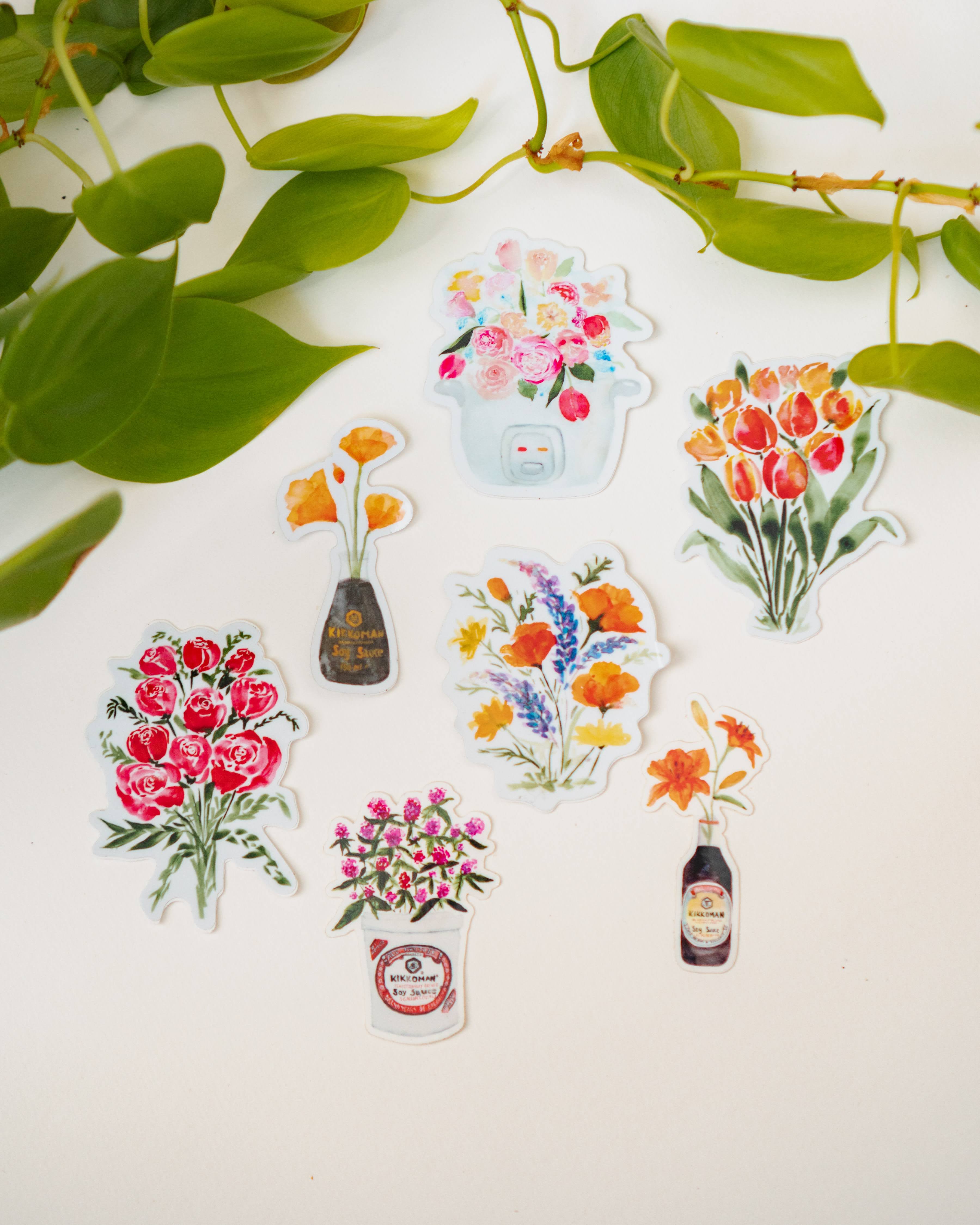 Seven stickers combining flowers and food-related items, including the artist's Soy Sauce Genesis series.