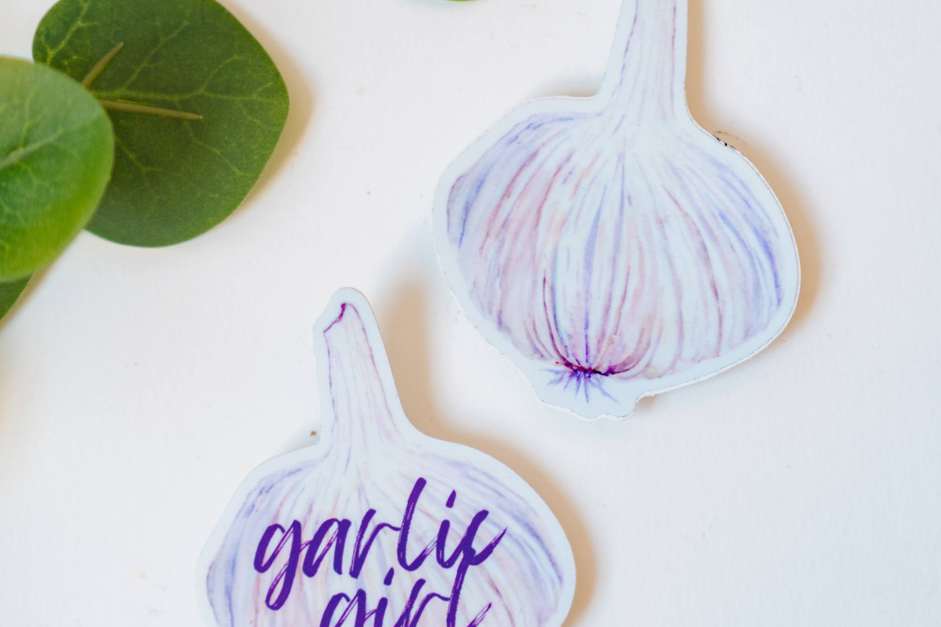 Two garlic bulb stickers, including the Garlic Girl Sticker.