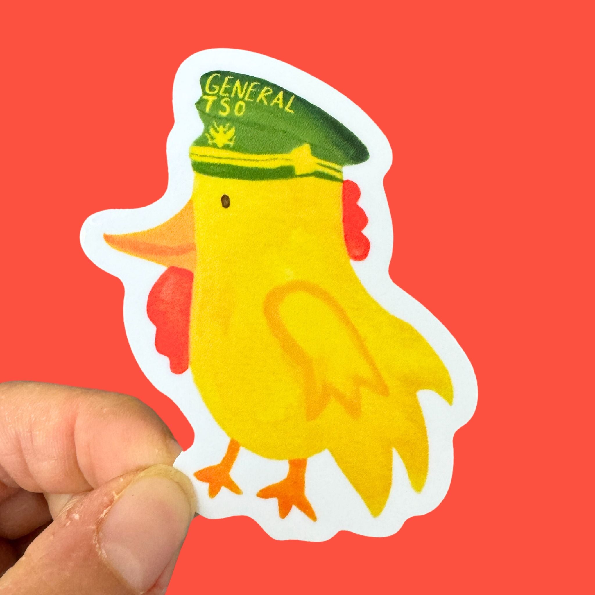 Scale of General Tso Sticker being held 