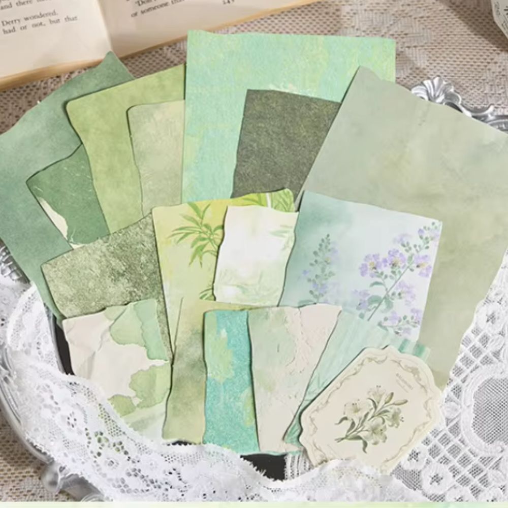 Assorted green vintage decorative papers with watercolor, floral, and marbled textures, plus a die-cut floral tag