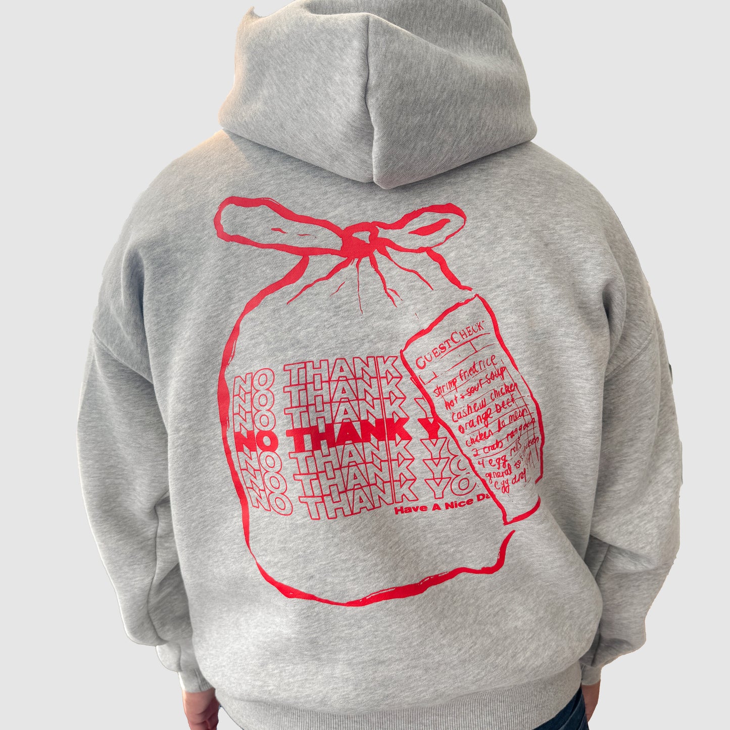 Grey hoodie with bag that says "no thank you" on the back 