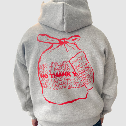 Grey hoodie with bag that says "no thank you" on the back 