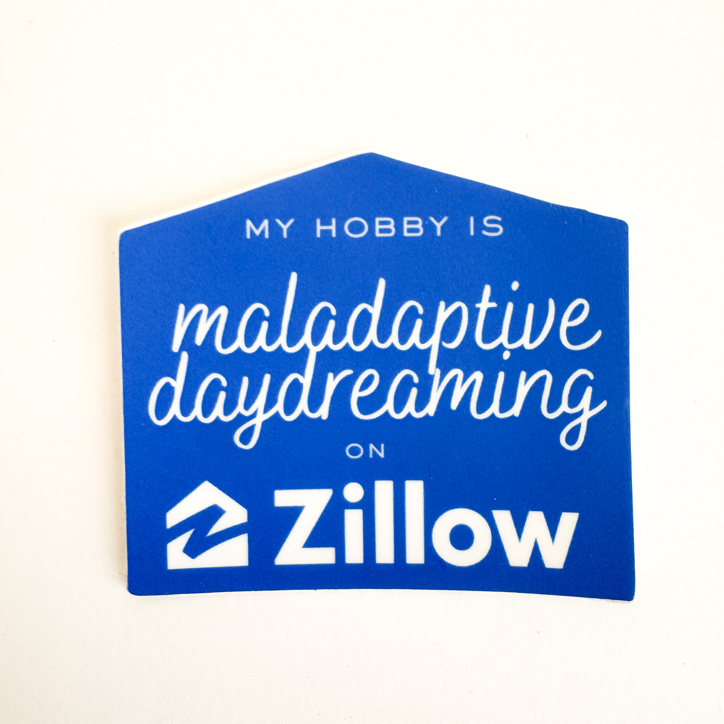 My Hobby Is Maladaptive Daydreaming on Zillow funny house-shaped vinyl sticker – blue die-cut decal with Zillow logo for laptop, water bottle, or journal