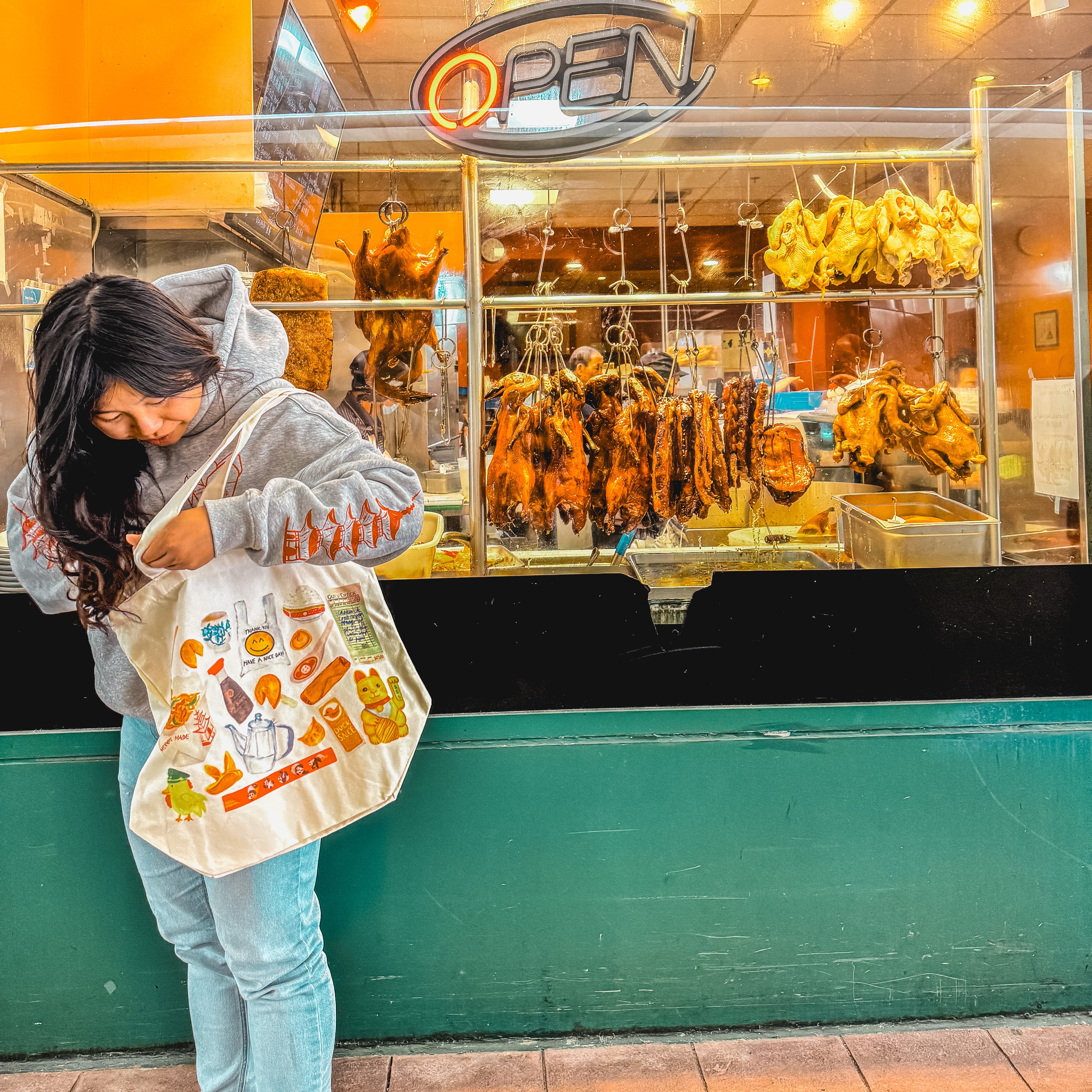 women carrying a tote bag with watercolor of classic Chinese takeout restaurant items