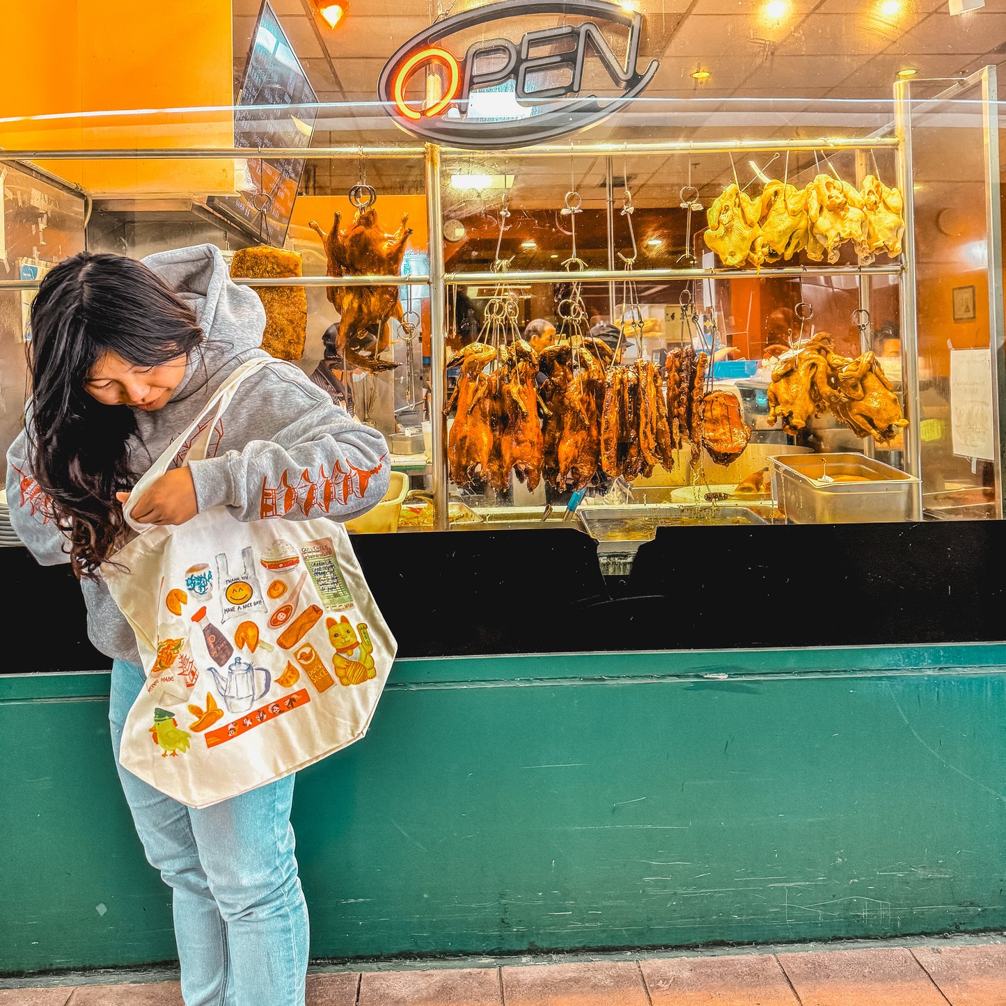women carrying a tote bag with watercolor of classic Chinese takeout restaurant items