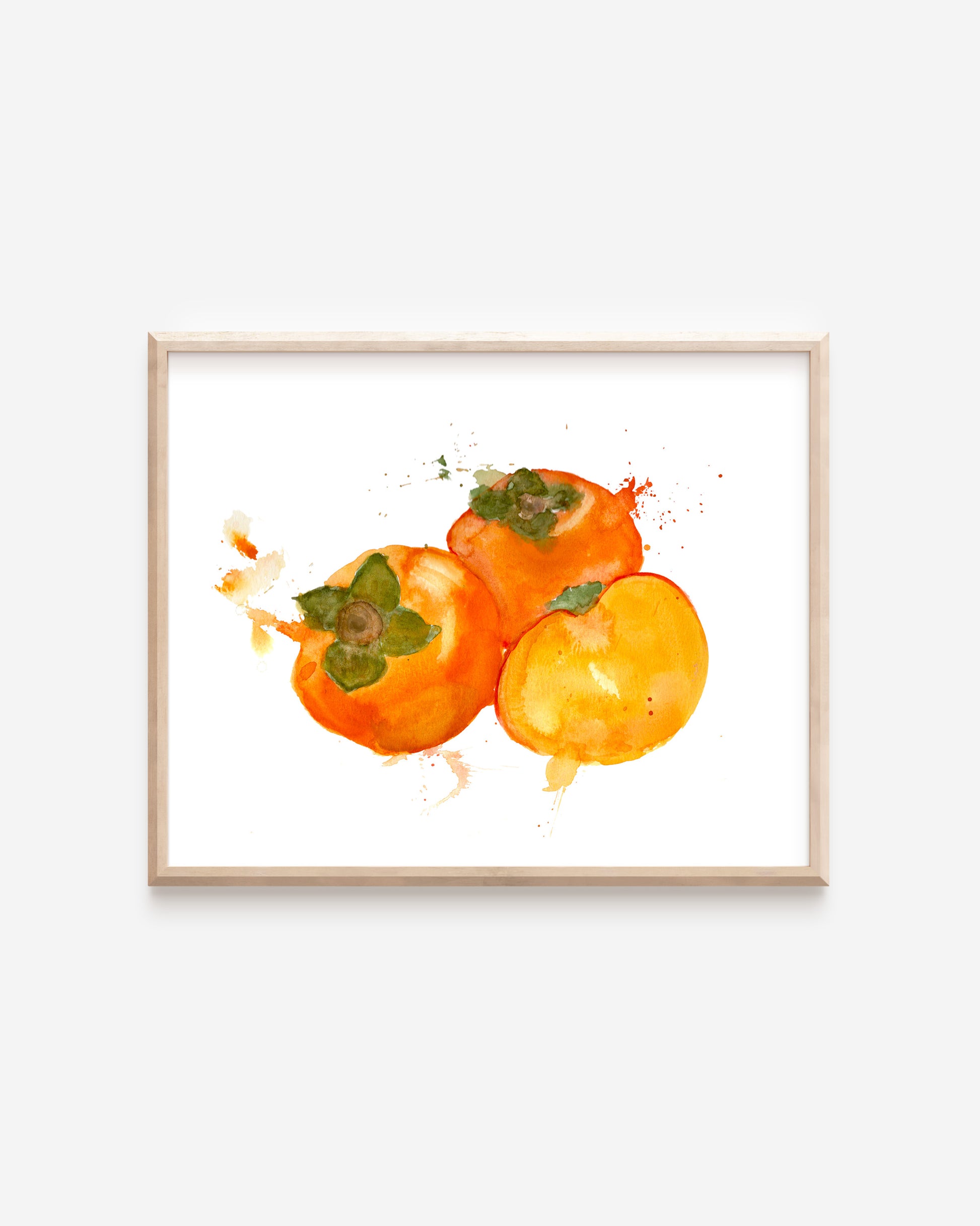 A print of three rich, orange watercolor persimmons. One persimmon is cut open to display the soft yellow-orange inside.