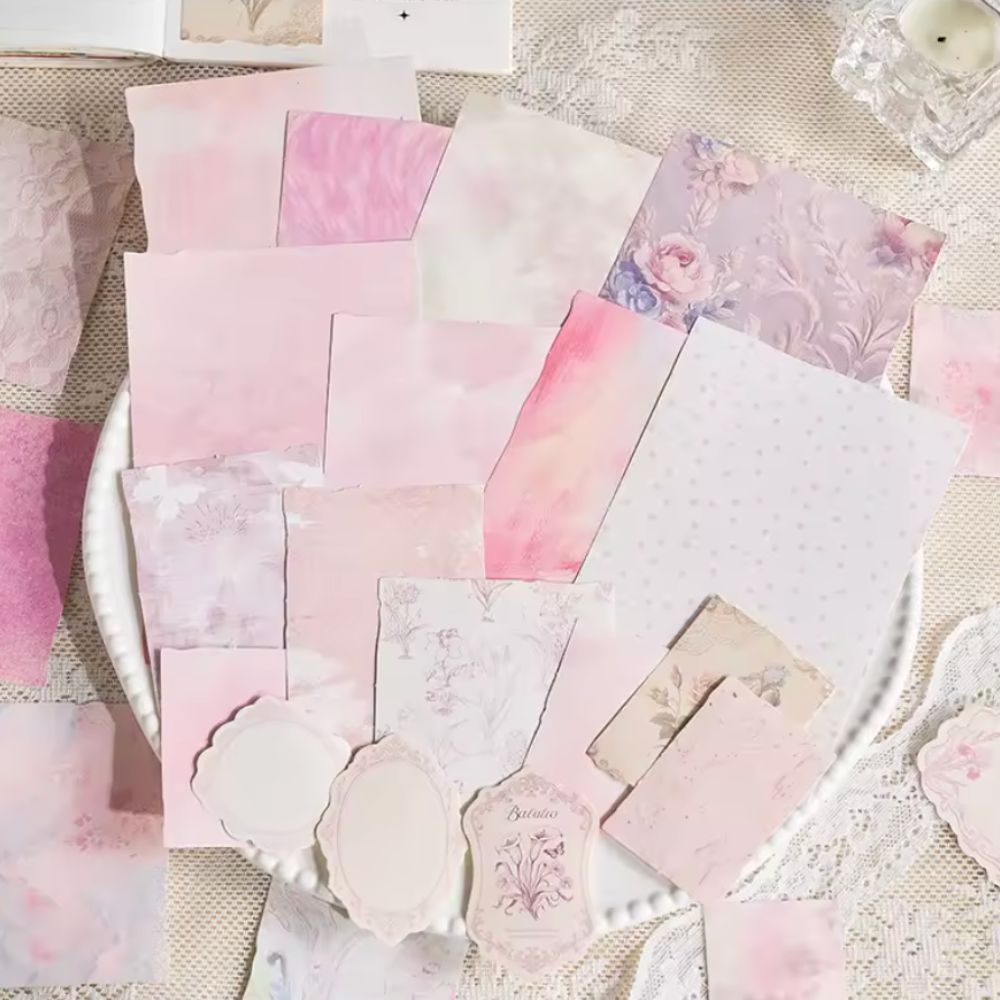 Assorted pink junk journal papers with watercolor, floral, damask, and polka dot prints, plus die-cut frame tags