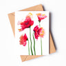 A soft, red and pink watercolor greeting cardof four California poppies. The petals are lit with soft, yellow accents.