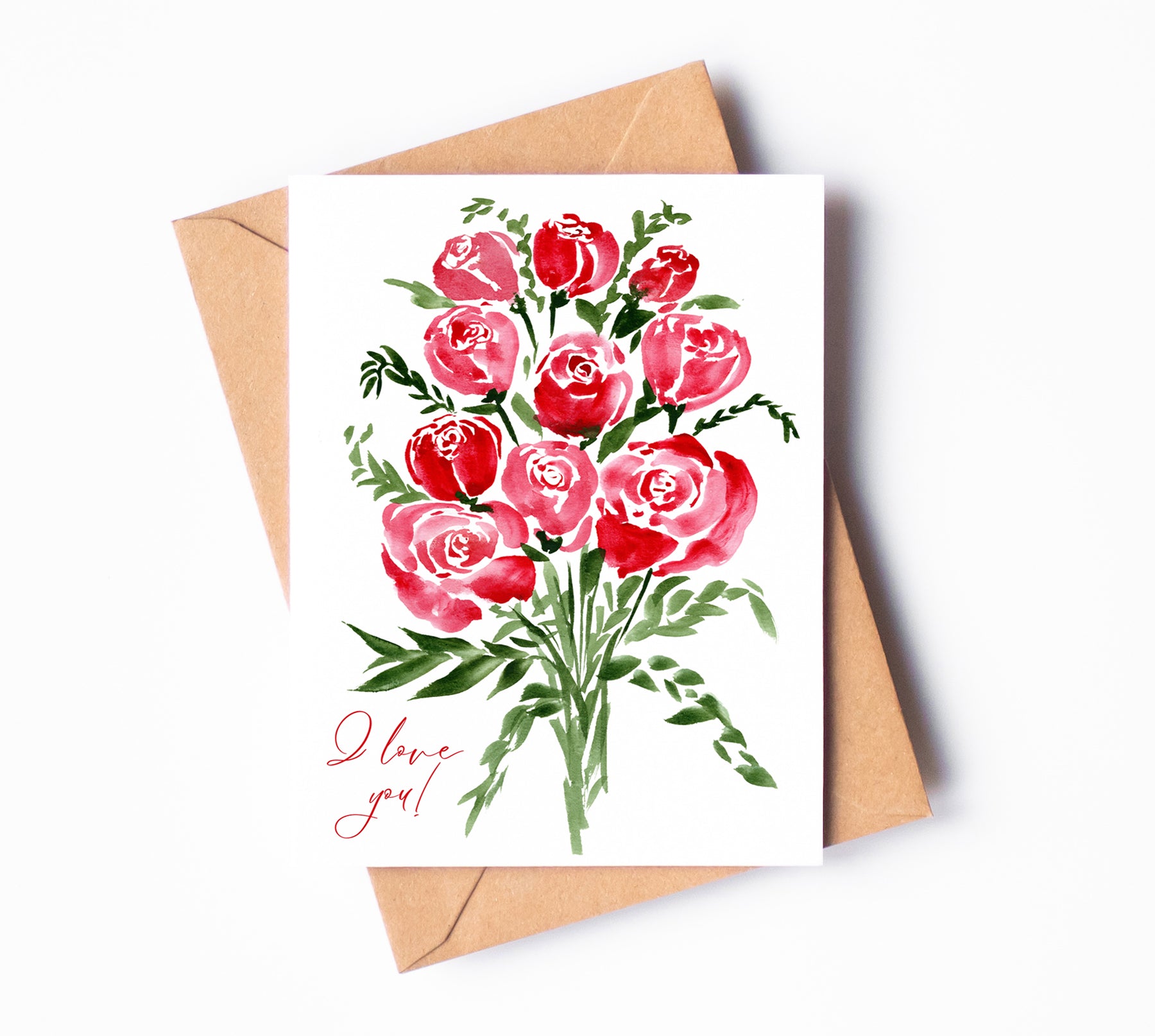 A white greeting card with red watercolor roses and "I love you!" written in thin, cursive script in the bottom left corner.