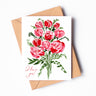A white greeting card with red watercolor roses and "I love you!" written in thin, cursive script in the bottom left corner.