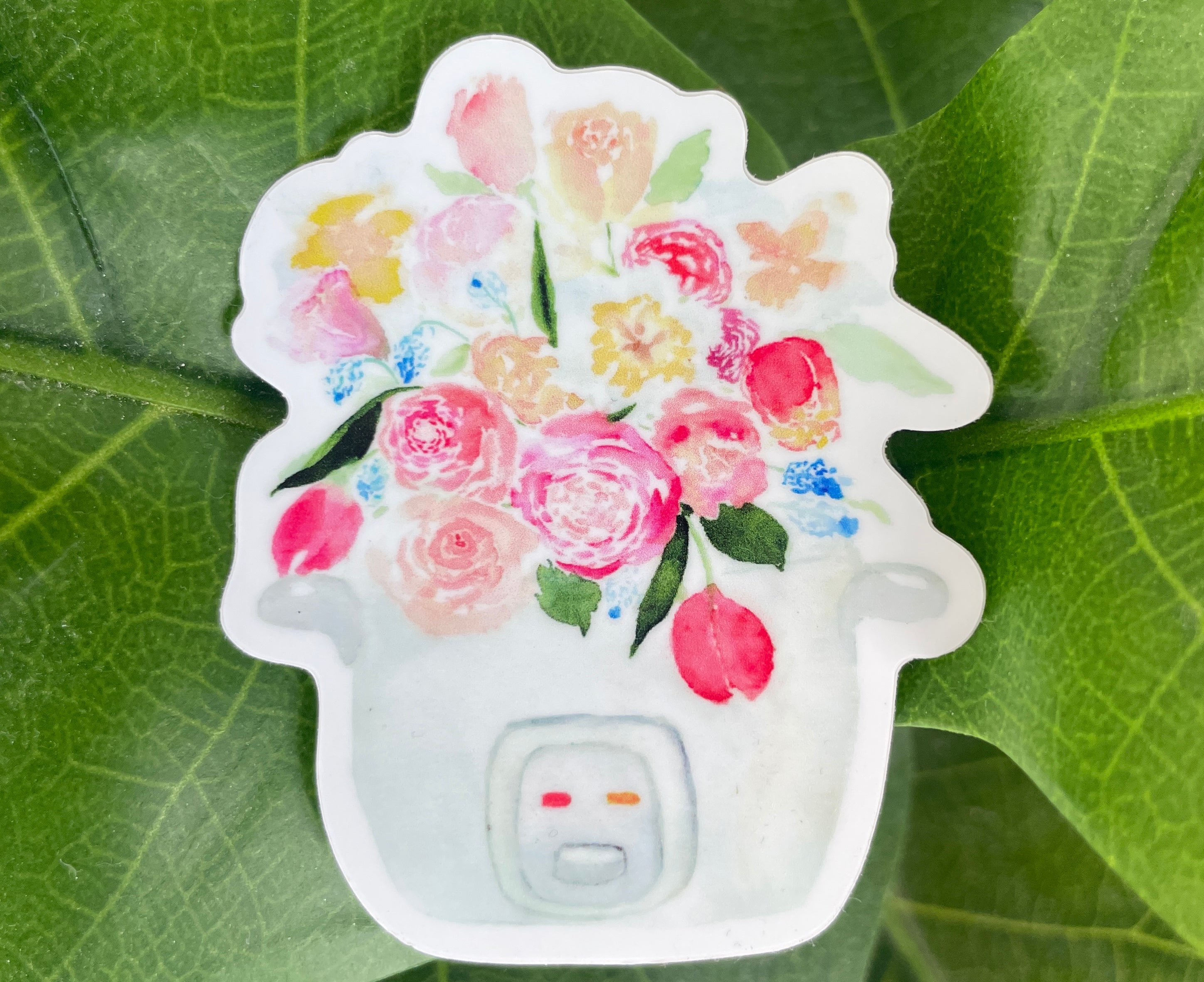 A pink, blue, and white sticker of a bouquet of tulips, roses, and other flowers sprouting out of a rice cooker.