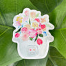 A pink, blue, and white sticker of a bouquet of tulips, roses, and other flowers sprouting out of a rice cooker.